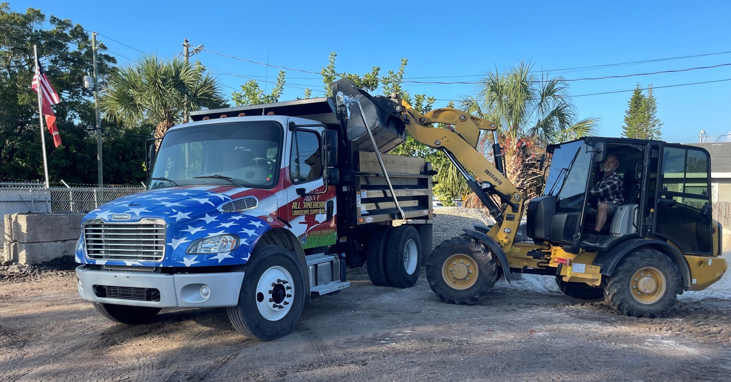 loading the all american landscape supply dump truck
